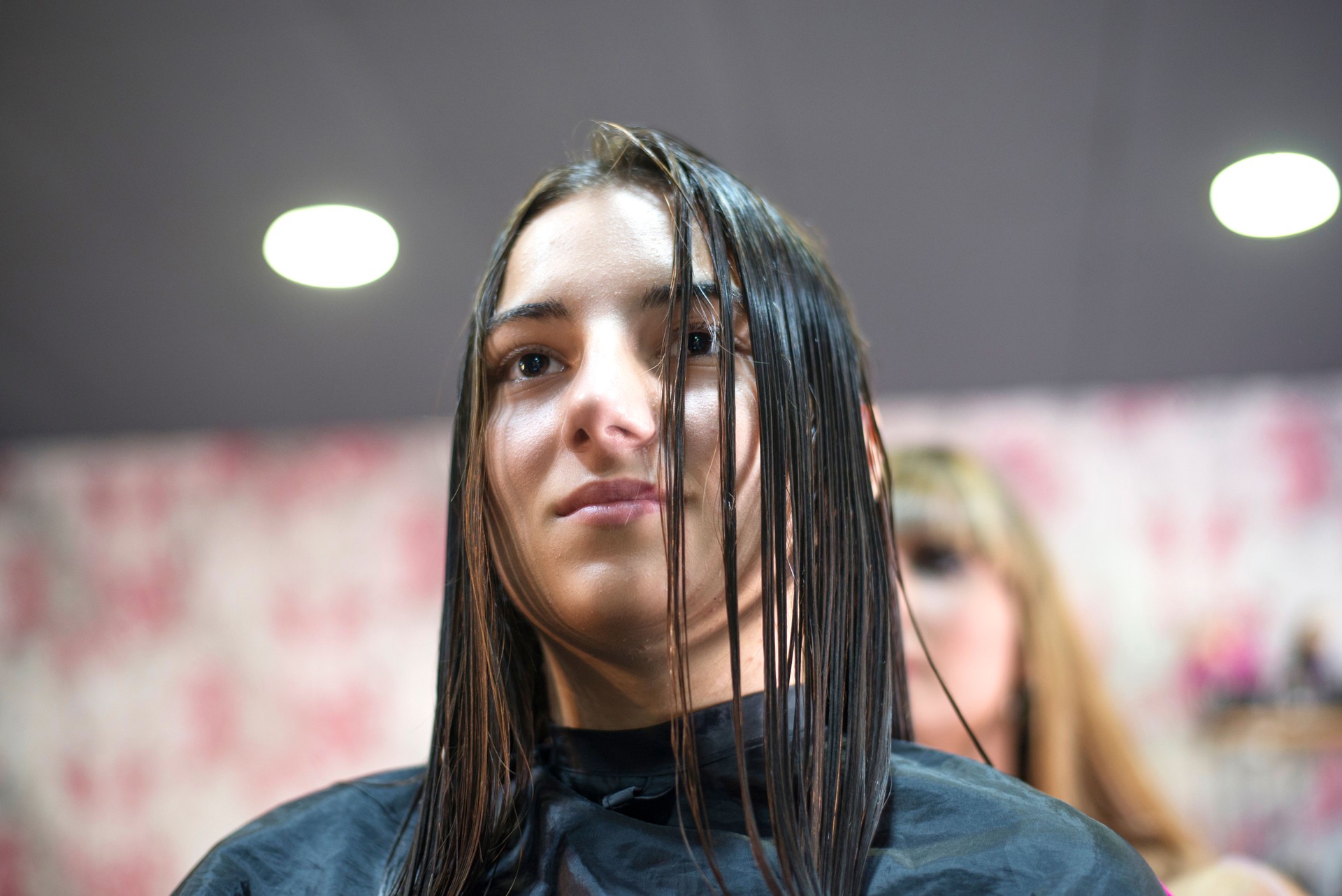 Woman in hair salon getting hair brushed